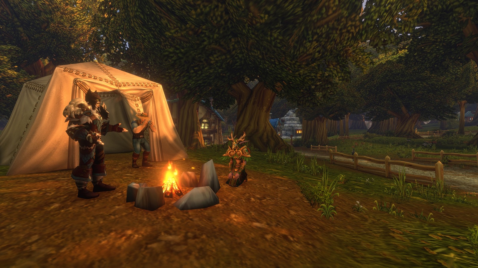 Adventurers gathered around a small campfire beside a canvas tent at the edge of a village under large trees