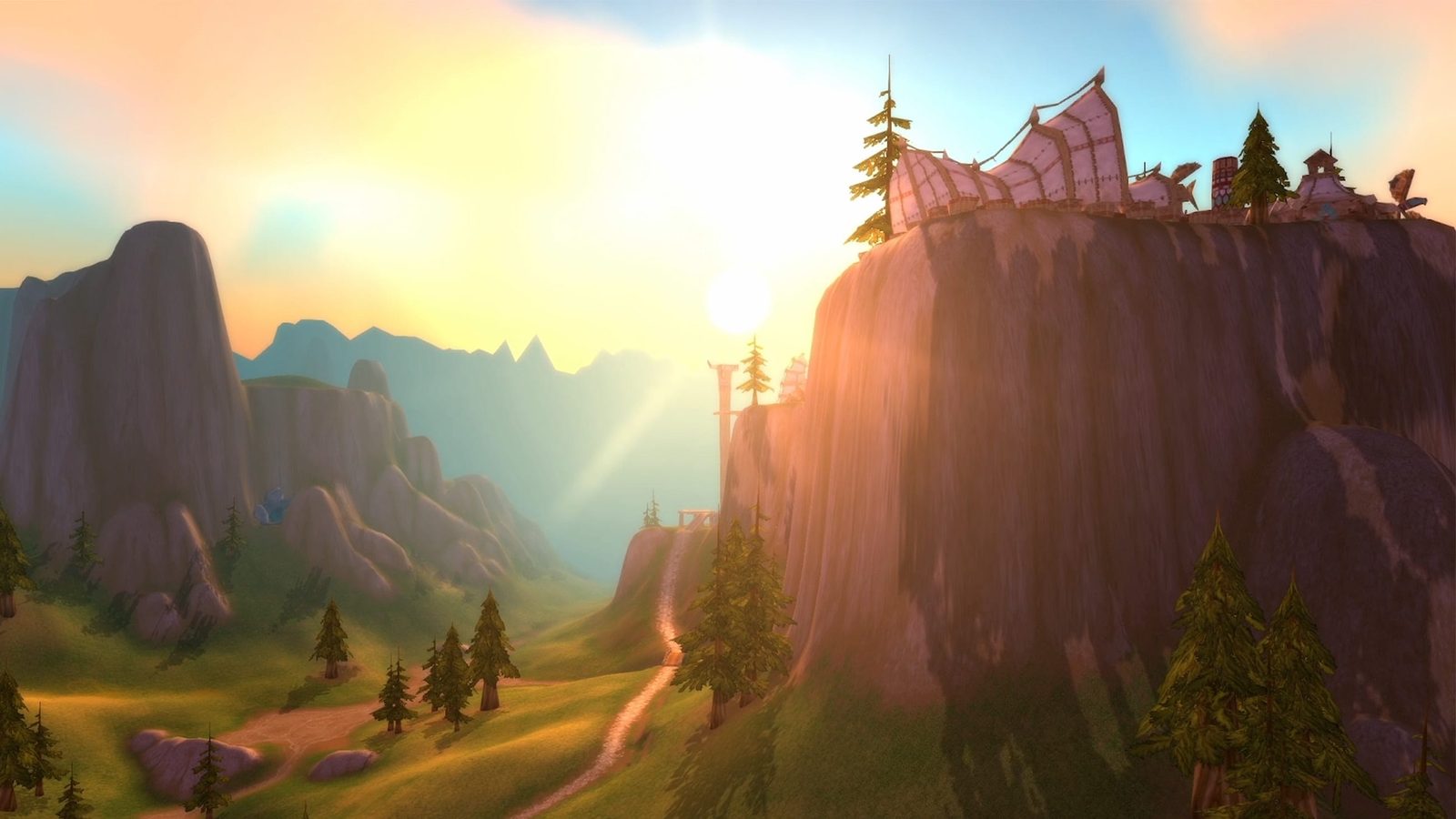 Screenshot of Mulgore at dusk: a Tauren mesa city on a cliff above rolling hills, updated lighting