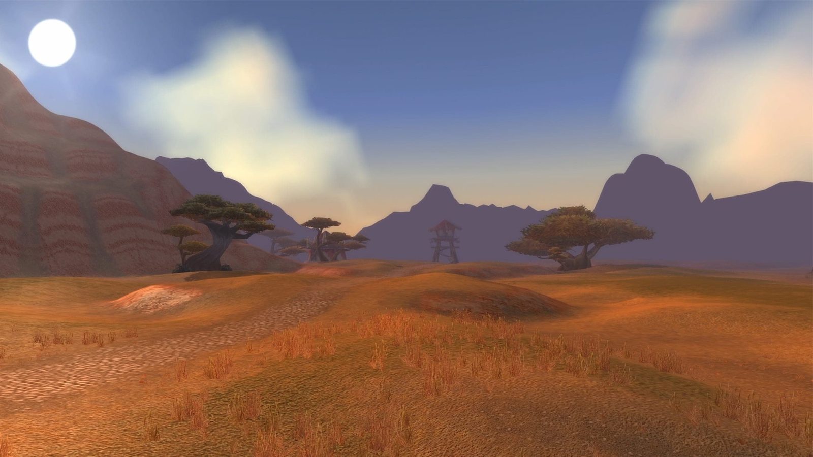 Screenshot of the Barrens at midday: red earth, scattered trees and distant mesas under a bright sky, updated lighting